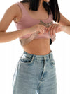 Elegant nude lace insulin pump belt being adjusted for a comfortable fit around the chest and waist.